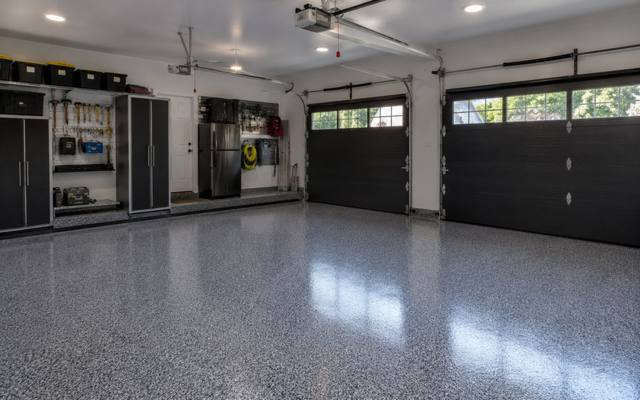 Dark grey flake epoxy floor in a two-car garage in Sherwood Park, Alberta